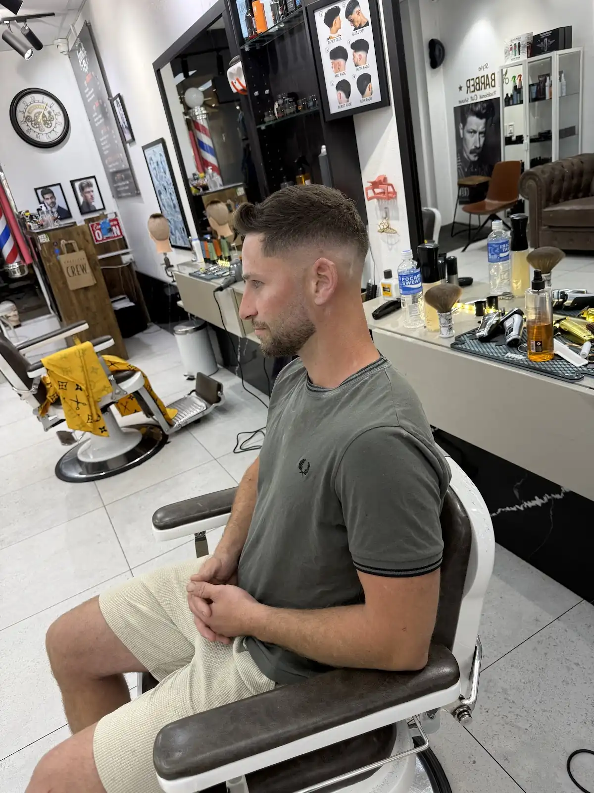 Inside Sharps Barber Shop: a client in the chair, mirrors and the barber pole